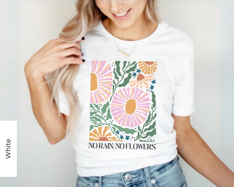 May include: White t-shirt with a floral design and the text "NO RAIN, NO FLOWERS".