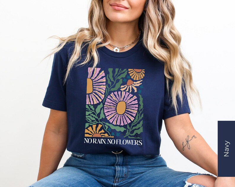 May include: A navy blue t-shirt with a floral graphic and the text "NO RAIN, NO FLOWERS".