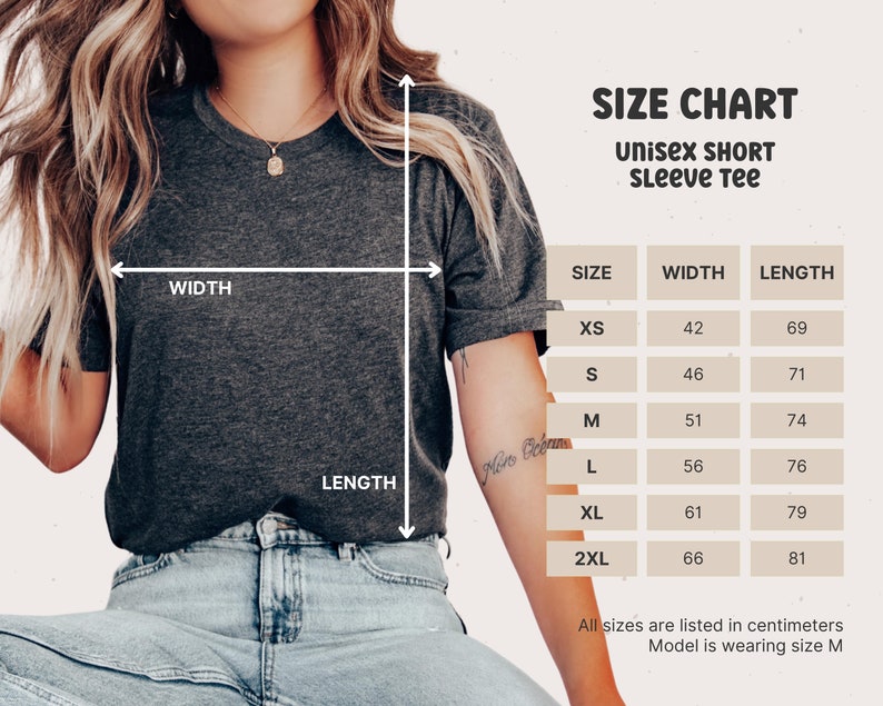 May include: Size chart for a unisex short sleeve tee. The chart shows the width and length measurements in inches for sizes XS, S, M, L, XL, and 2XL.