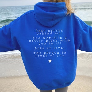 May include: A royal blue hoodie with a white message on the back that reads: "Dear person behind me: The world is a better place with you in it! Lots of love, The person in front of you".