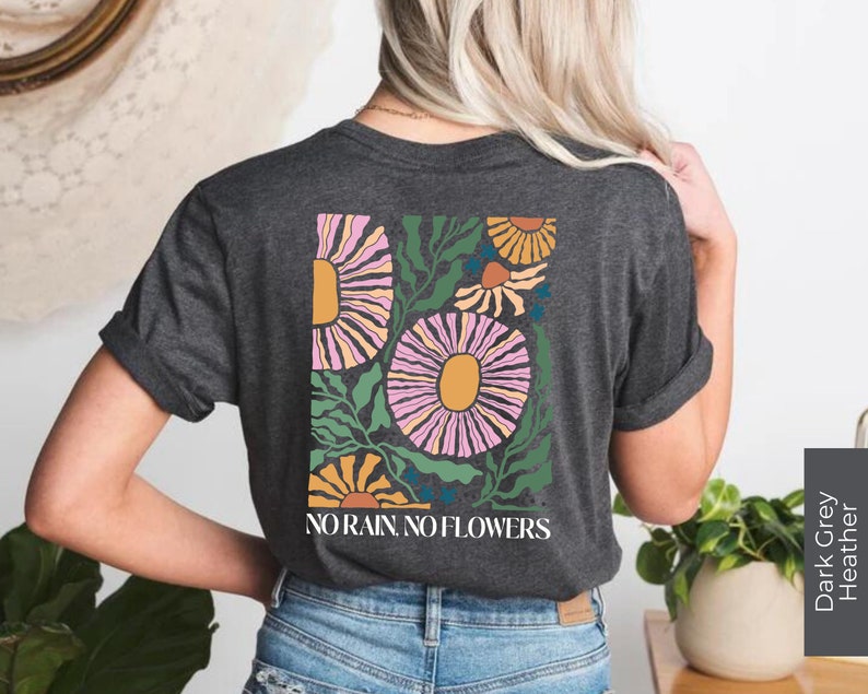 May include: A dark grey heather t-shirt with a floral design and the text "NO RAIN. NO FLOWERS." printed on the back.