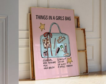 May include: A framed poster with a pink background and gold trim. The poster features a teal handbag illustration with the text "THINGS IN A GIRLS BAG" and a list of items including a journal, mini perfume, and lip gloss.