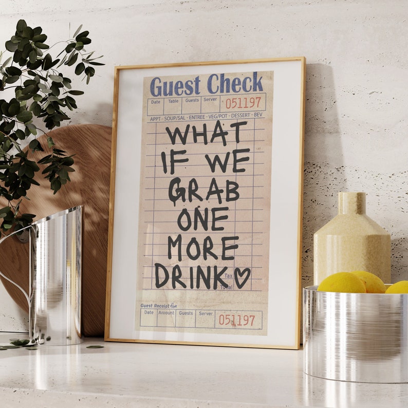 May include: A framed print of a vintage guest check with the text "What if we grab one more drink" written in black marker. The check has a date of 051197 and a server number of 051197.