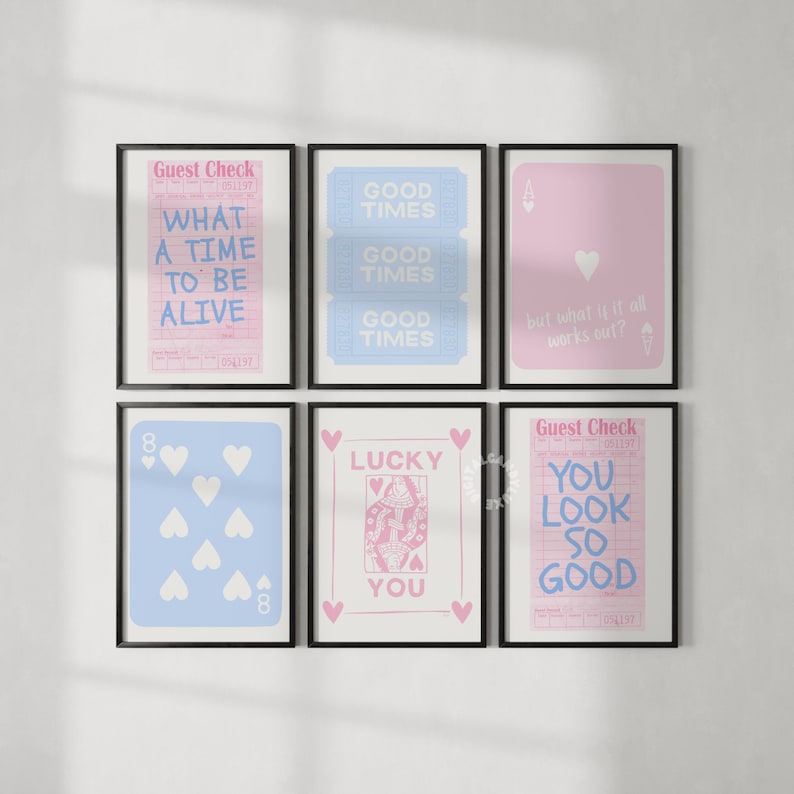 May include: Six framed prints with a pink and blue color scheme. The prints feature text and images, including a guest check, a playing card, and a heart design. The text on the prints includes "What a time to be alive", "Good Times", "Lucky You", and "You look so good".