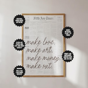 May include: A framed print featuring a vintage newspaper design with the headline "Fifth Ave Times." The artwork displays the words "make love, make art, make money, make out" in a handwritten style. The print is surrounded by black starbursts with text.