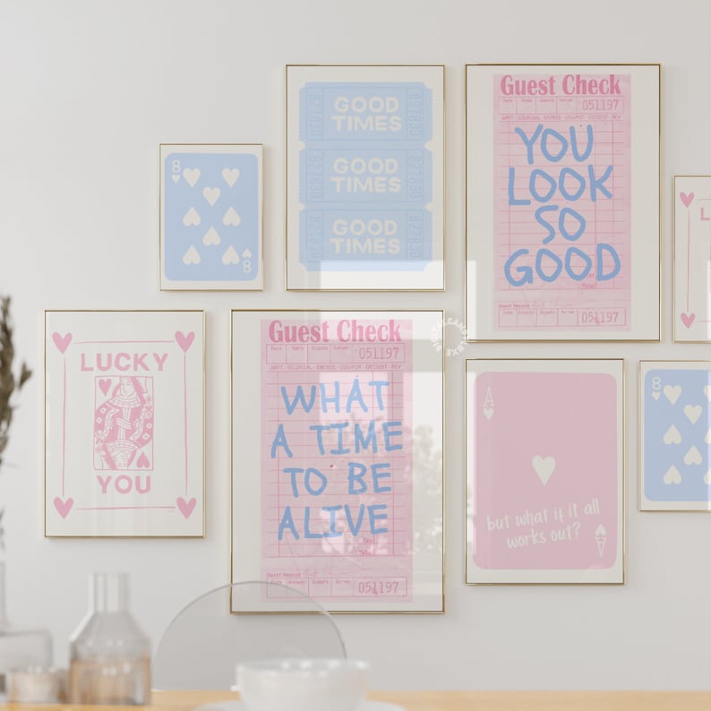 May include: A collection of nine framed prints with a pastel color scheme. The prints feature various designs, including playing cards, a guest check with the text "What a time to be alive", and a guest check with the text "You look so good".