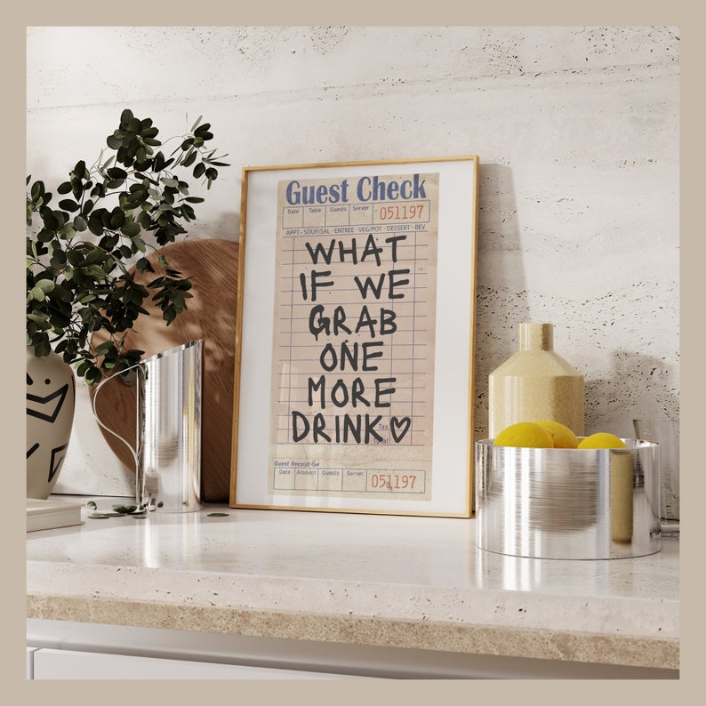 May include: A framed print of a guest check with the text "What if we grab one more drink" written on it. The check is dated 05/11/97.