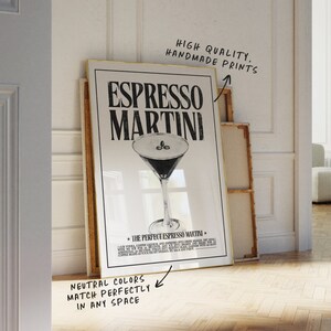 May include: A black and white poster with a gold frame featuring a martini glass with coffee beans and the text "Espresso Martini" and "The Perfect Espresso Martini". The poster has a white background and the text is in a bold, sans-serif font.