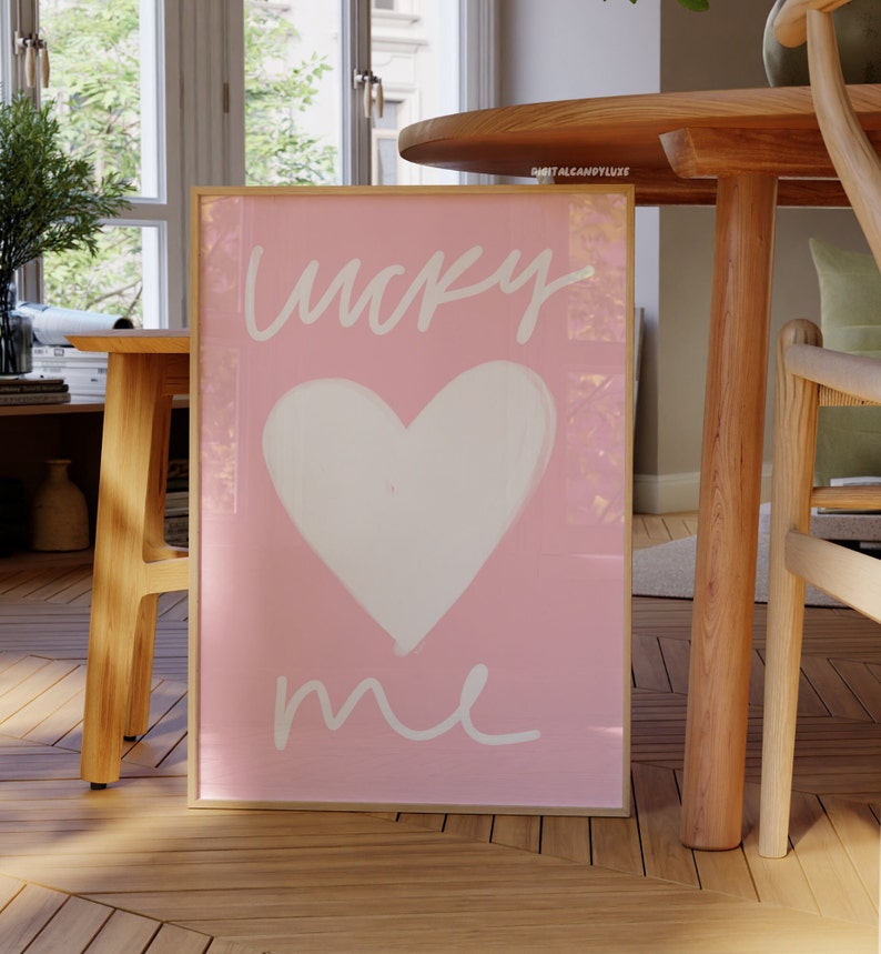 May include: A pink framed print with a white heart and the text "lucky me" in white script.