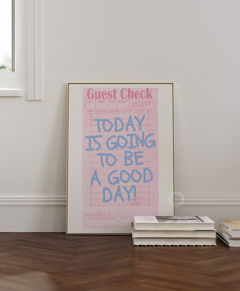 May include: A pink and white guest check with the text "TODAY IS GOING TO BE A GOOD DAY!" written in blue. The check has a grid pattern and the words "Guest Check" are printed at the top.