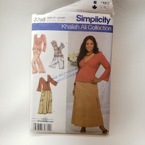 Peut inclure: Patron de couture Simplicity 3768 pour les tailles 18W-24W. Le patron comprend une jupe marron avec des poches et un haut rouge avec un détail torsadé. Le patron fait partie de la collection Khaliah Ali.