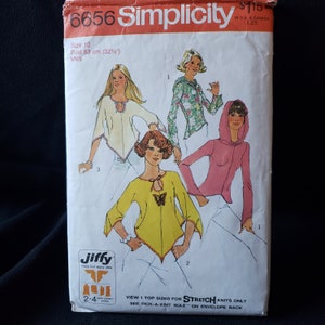 May include: Simplicity sewing pattern number 6656 for a top. The pattern includes three different views: a white top with a keyhole neckline, a yellow top with a butterfly detail, and a pink top with a hood. The pattern is sized for stretch knits only and includes instructions for a pick-a-knit rule.