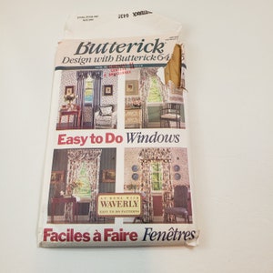 May include: A vintage Butterick sewing pattern for window treatments. The pattern features images of curtains and valances in various styles. Text includes "Easy to Do Windows" and "Faciles à Faire Fenêtres". The pattern is slightly torn.