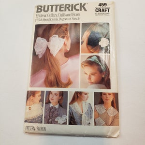 May include: A vintage sewing pattern booklet titled "Butterick Craft 459" with the text "12 Great Collars, Cuffs and Bows" and "12 Cols Sensationnels, Poignets et Noeuds". The booklet features illustrations of women wearing different styles of collars, cuffs, and bows.