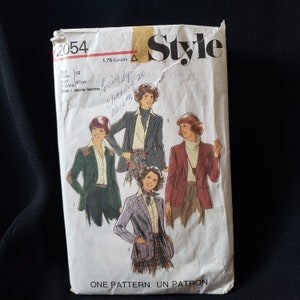 May include: A vintage sewing pattern envelope featuring a photo of four women modelling different jackets. The pattern number is 2054 and the size is 12, bust 87 cm. The text on the envelope reads "Style" and "One Pattern Un Patron".
