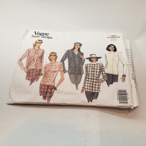 May include: A Vogue Basic Design sewing pattern packet featuring illustrations of various women's clothing styles. The designs include a cardigan, a short-sleeved top, a double-breasted blazer, a houndstooth jacket, and a turtleneck. The packet is white with black text and illustrations.