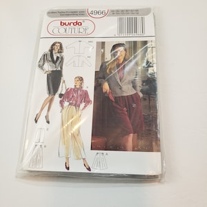 May include: A Burda Couture sewing pattern packet, showing illustrations of women's clothing designs. The packet includes images of a blazer, skirt, and trousers. The packet is sealed in clear plastic.