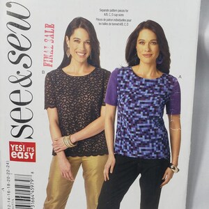 May include: A sewing pattern package featuring two women modeling tops. One woman wears a black lace top with gold pants, and the other wears a purple and blue geometric top with black pants. The package includes the text "Final Sale."