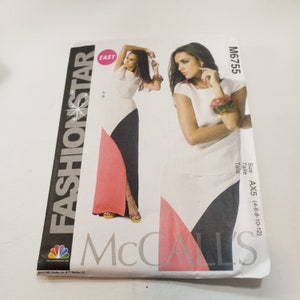May include: A McCall's Fashion Star sewing pattern for a maxi dress with a white, black, and pink color scheme. The pattern number is M6755 and the size is AX5 (14-16-18-20).