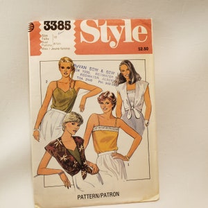 May include: A sewing pattern for a sleeveless top with a tie detail. The pattern is for size 12 and includes instructions for making three different styles of tops. The pattern is from RyVan Sew & Sew, located in Redwater, Alberta, Canada.