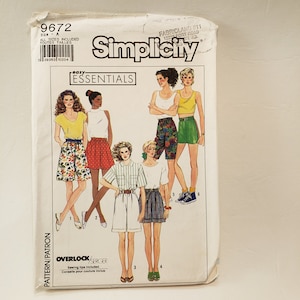 May include: Simplicity sewing pattern number 9672, size A, easy essentials, includes instructions for making four different styles of shorts. The pattern includes a floral print, a red and white polka dot print, a white pair of shorts, and a striped pair of shorts.