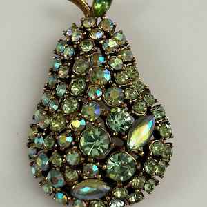 Rare vintage Arthur Pepper pear brooch. Gold tone with green aurora borealis, rhinestone, and opalescent stones. Signed ART pin.