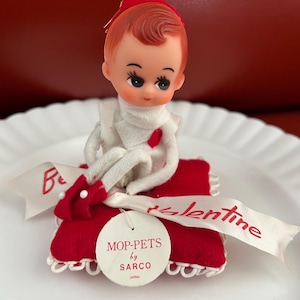 Vintage knee hugger elf on red Valentines pillow. Mop-pets pixie doll made in Japan by Sarco. Never used in original bag with tags.