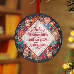May include: Round Christmas ornament with a black background and colorful illustrations of Christmas ornaments, toys, and a Santa Claus. The ornament has a white diamond-shaped design in the center with the text "Frohe Weihnachten und ein gutes neues Jahr".