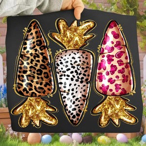 May include: Black decorative pillow featuring three stylized carrots with gold glitter tops and bottoms. The carrot designs have leopard, dalmatian, and pink animal print patterns. The pillow is held up by a person.