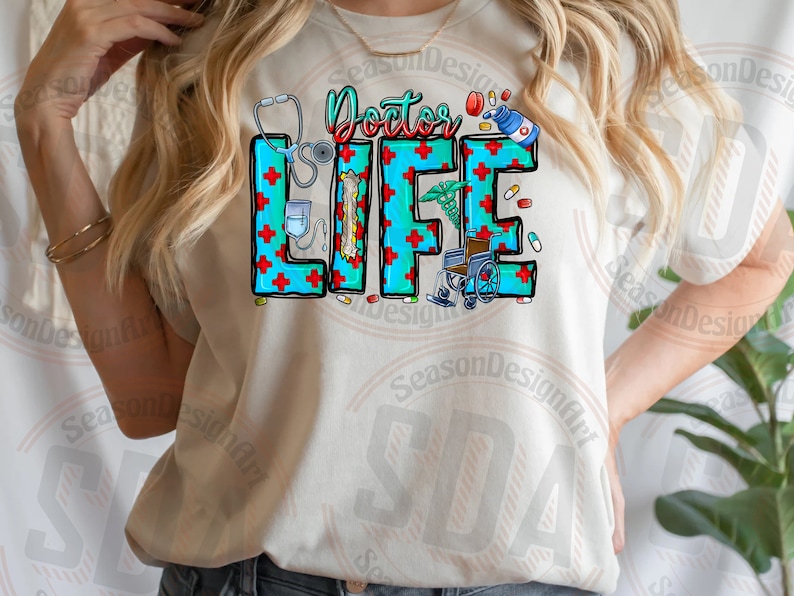 May include: A white t-shirt with the text "Doctor Life" in blue and red letters. The letters are decorated with medical symbols like a stethoscope, pills, and a wheelchair.