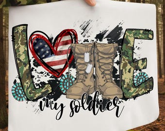 May include: White square fabric with the word "LOVE" in camouflage print and turquoise accents. A heart with the American flag design and combat boots with dog tags are featured. The words "my soldier" are written in cursive.