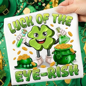 May include: White square graphic with a cartoon four-leaf clover character holding a vial and flask. The clover is smiling and surrounded by gold coins, a green hat, and a pot of gold. Text reads "LUCK OF THE EYE-RISH".