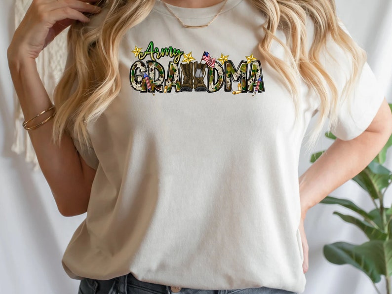 May include: A white t-shirt with a camouflage print design that says "Army Grandma" with a small American flag and stars.