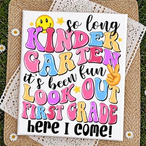 May include: A white canvas print with the text "So long Kindergarten fun, it's been fun, look out first grade here I come!" in colorful bubble letters. Includes a yellow smiley face and a peace sign.