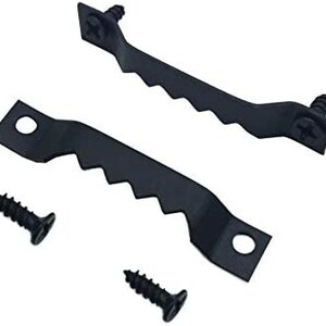 May include: Two black metal picture hanging hooks with four black screws. The hooks have a serrated edge and two holes for hanging.