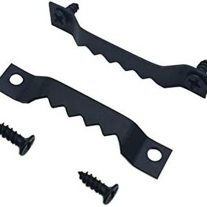 May include: Two black metal picture hanging hooks with four black screws. The hooks have a serrated edge and two holes for hanging.