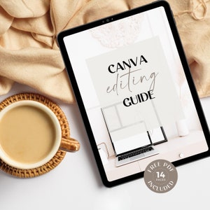 May include: A digital tablet displaying a Canva editing guide with the text "CANVA editing GUIDE" and "FREE PDF 14 PAGES INCLUDED". The tablet is on a white surface with a cup of coffee and a beige blanket in the background.