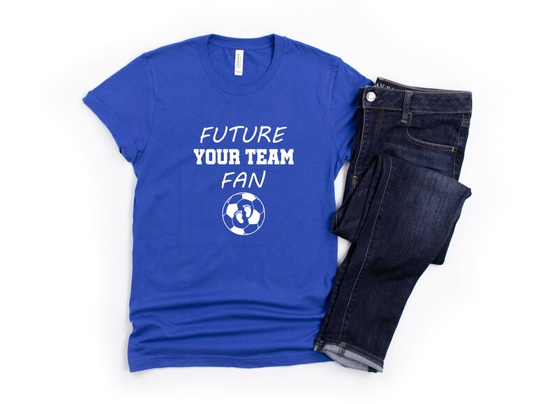 May include: A royal blue t-shirt with white text that reads "Future Your Team Fan" and a soccer ball with footprints on it.