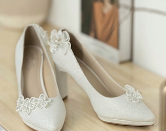 White wedding shoes covered with beautiful shimmering rhinestones. 10cm high heel bridal shoes.