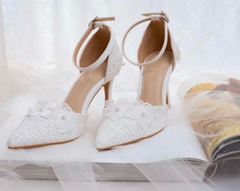 Wedding shoes with flowers for the bride. Sandals. Sparkling lace bridal shoes.
