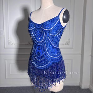 Evening dresses. Mini dresses. Fringe mini dresses. Gorgeous jumpsuits. Beads dress.Blue jumpsuit. Gorgeous performance costumes.
