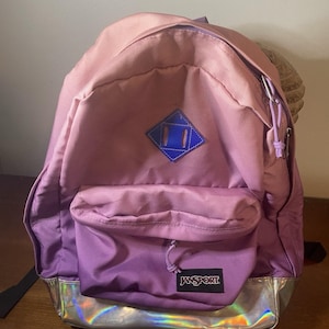 image for super fx backpack from jansport online store The JanSport Super FX Series is made with premium fabric and has fun graphics and embroideries Jansport Super FX Backpack |
