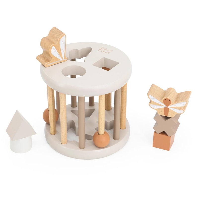 May include: A wooden shape sorter toy with a gray base and wooden dowels. The toy includes a butterfly, a dragonfly, a star, a square, a circle, and a triangle. The toy is labeled "label label".