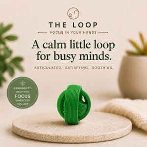 May include: A bright green, spherical, articulated fidget toy with a ribbed texture. The text reads: THE LOOP, FOCUS IN YOUR HANDS, A calm little loop for busy minds. ARTICULATED. SATISFYING. SOOTHING. DESIGNED TO HELP YOU FOCUS WHEREVER YOU ARE.
