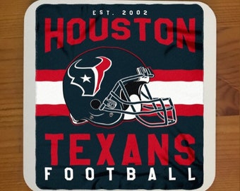 May include: A white, blue and red Houston Texans football team logo with the text "EST. 2002 HOUSTON TEXANS FOOTBALL" on a dark blue background.