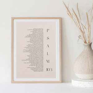 May include: A framed print of Psalm 103 from the Bible. The text is printed in black on a light beige background with a subtle grid pattern. The psalm number is printed in a larger font size at the bottom of the print.