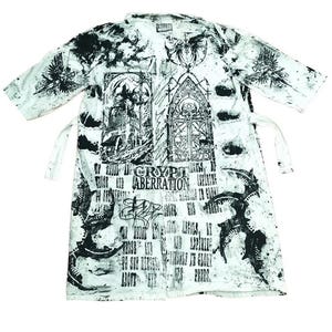 May include: A white long-sleeved shirt with a black and white print. The print features gothic-style imagery, including a large window with a single eye, and the text "CRYPT ABERRATION".