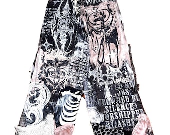 May include: Black and white wide-leg pants with a distressed design. The pants feature various graphic prints, including text, skulls, and abstract patterns. Patches of pink and textured fabric are sewn into the design.