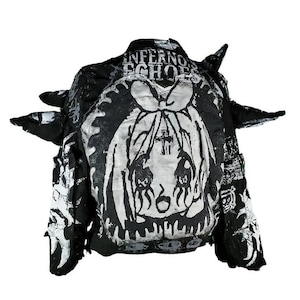 May include: Black and white jacket with a graphic print of a cartoon character with the text "Infernos Echoes" on the back.
