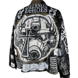 May include: A black denim jacket with a white and black graphic print of a gas mask with a cross on the front. The jacket has the words "Inferno's Echoes" printed on the back.